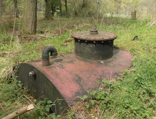 Metal Tank Buried in the Ground in a Woodland Setting within The Lake District National Park in Rural Cumbria, England, UK