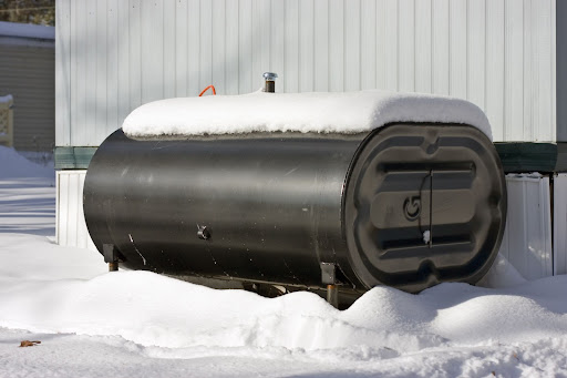 aboveground oil tank covered and surrounded by snow