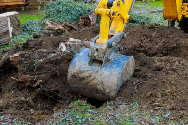 A bulldozer digging into the soil.